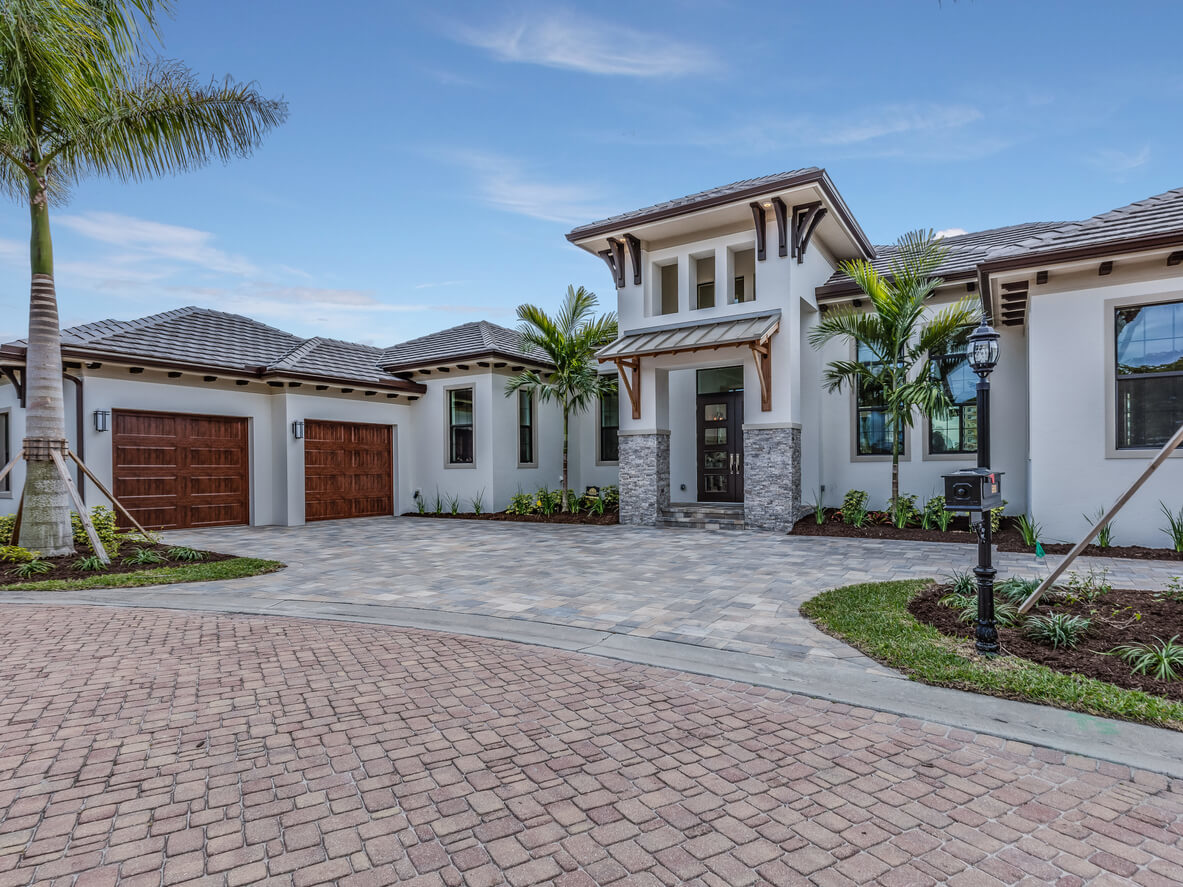 Custom home exterior with palm trees in Estero, Florida